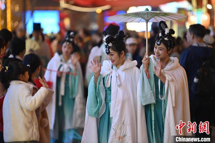 圖為街區(qū)人員著傳統(tǒng)服飾與游人互動(dòng)。李亞龍 攝</p><p>